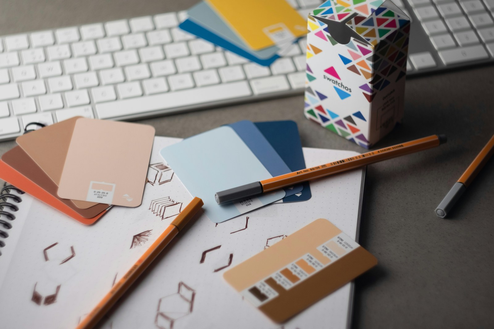 Brand colour studies and design materials on a creative desk